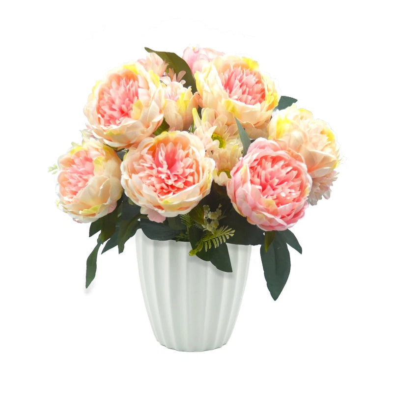 Artificial peony flower bouquet with pastel pink and cream blooms in white ceramic vase