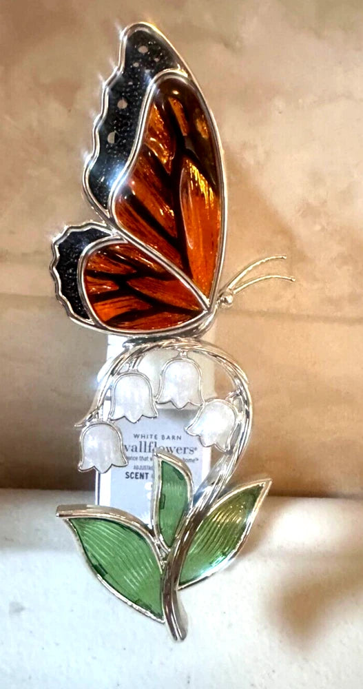Plug-in wallflower nightlight, amber butterfly wings with white lily blooms and green leaves