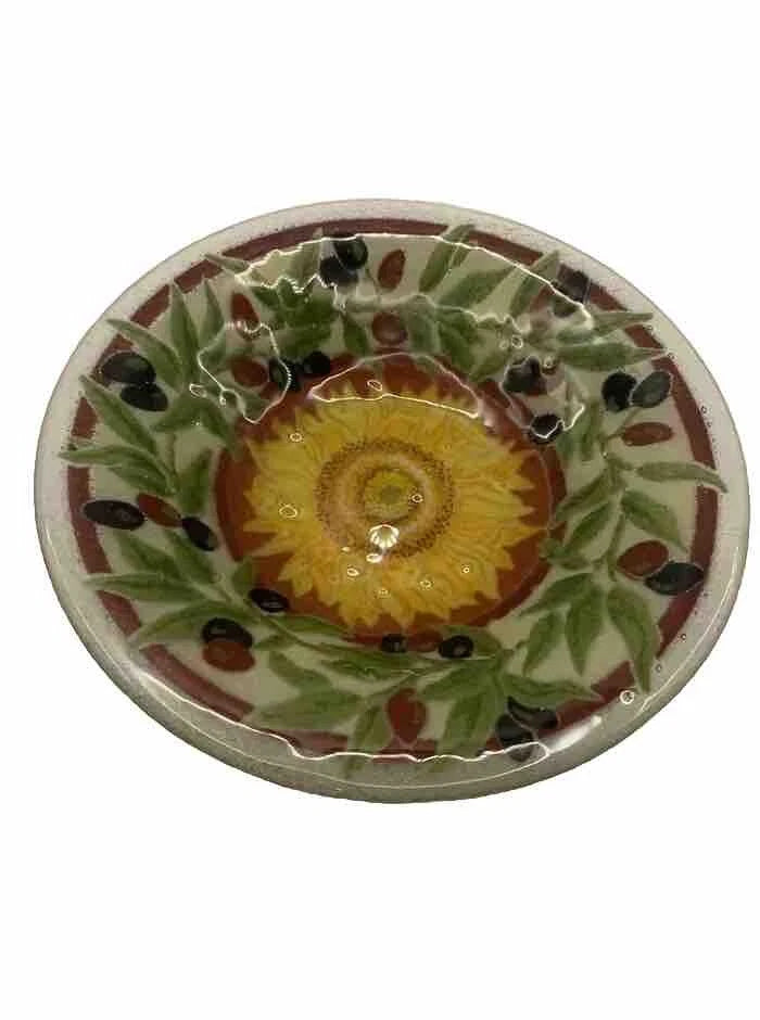 Fused glass bowl with yellow sunflower center, green leaves, and dark olive accents
