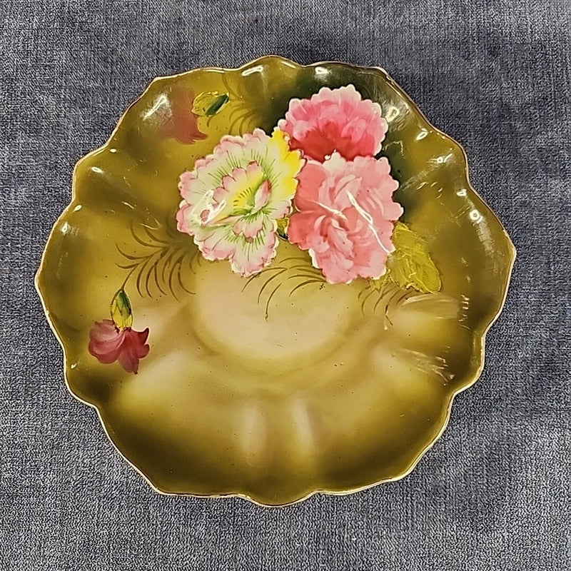 Hand-painted porcelain bowl with pink carnations on scalloped yellow glaze.