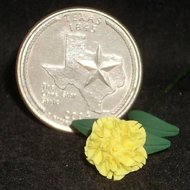 Miniature yellow carnation flower with green leaves, small dollhouse accessory