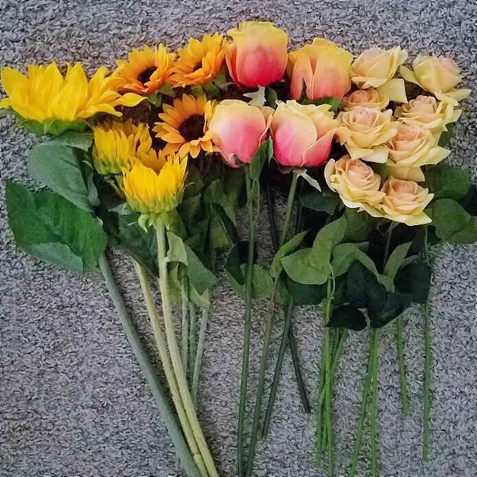 Set of artificial flower stems with yellow sunflowers, pink roses, and green leaves