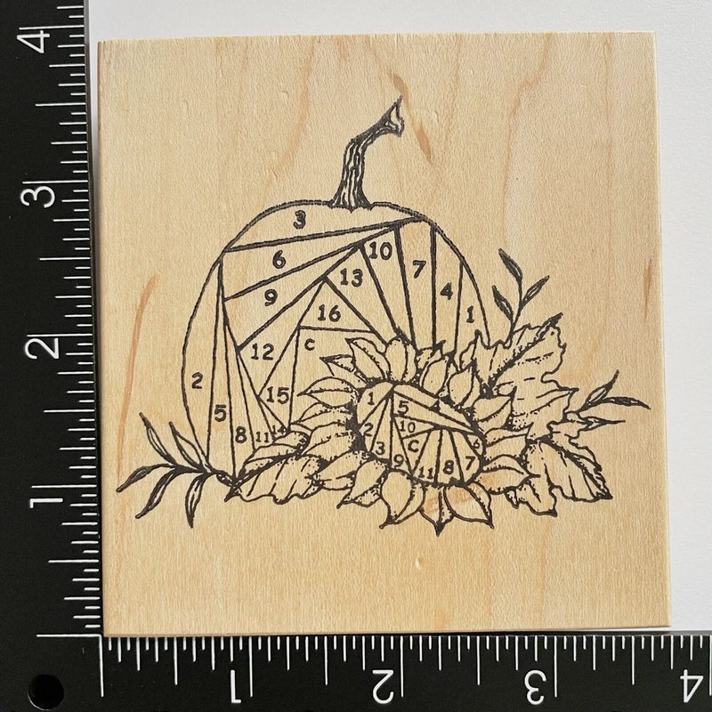 Floral rubber stamp with pumpkin outline, sunflower and leaf design on wooden block