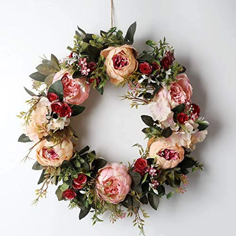 Pink and red artificial floral wreath with peony-style blooms and greenery