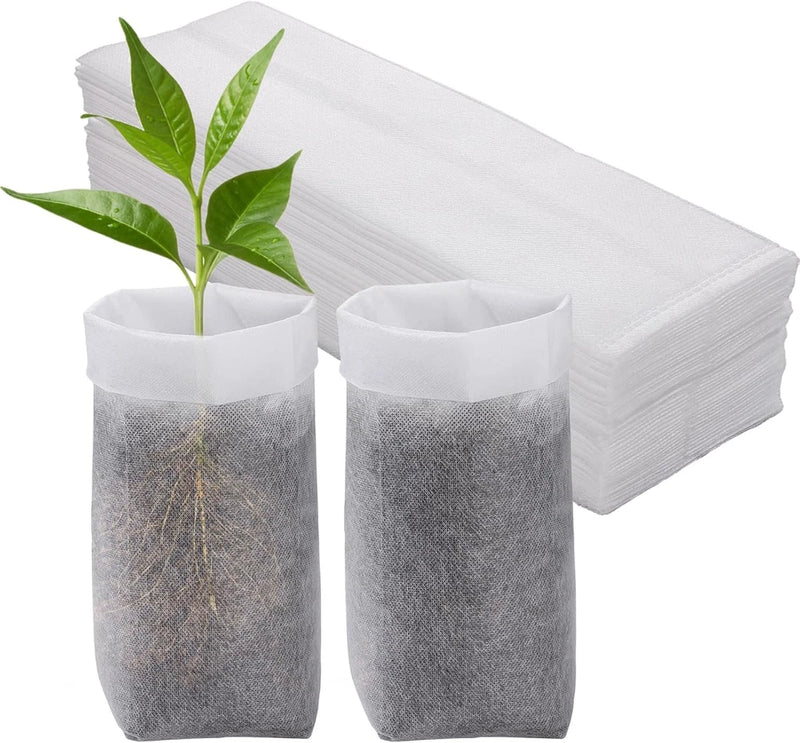 Non-woven nursery grow bag set: two grey fabric planting pots with white tops and plants