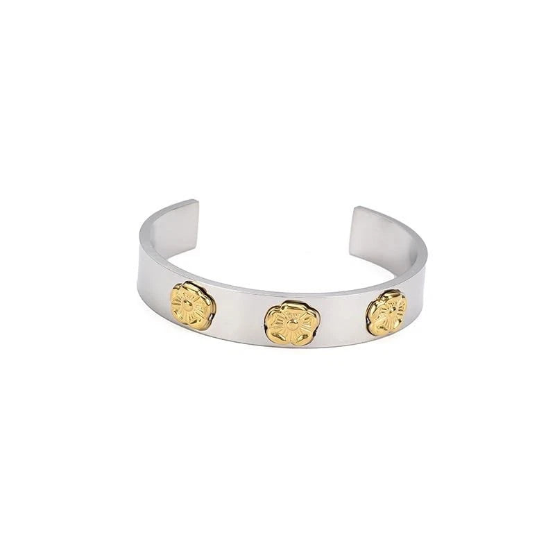 Gold tone open cuff bangle bracelet with three small sunflower charm discs