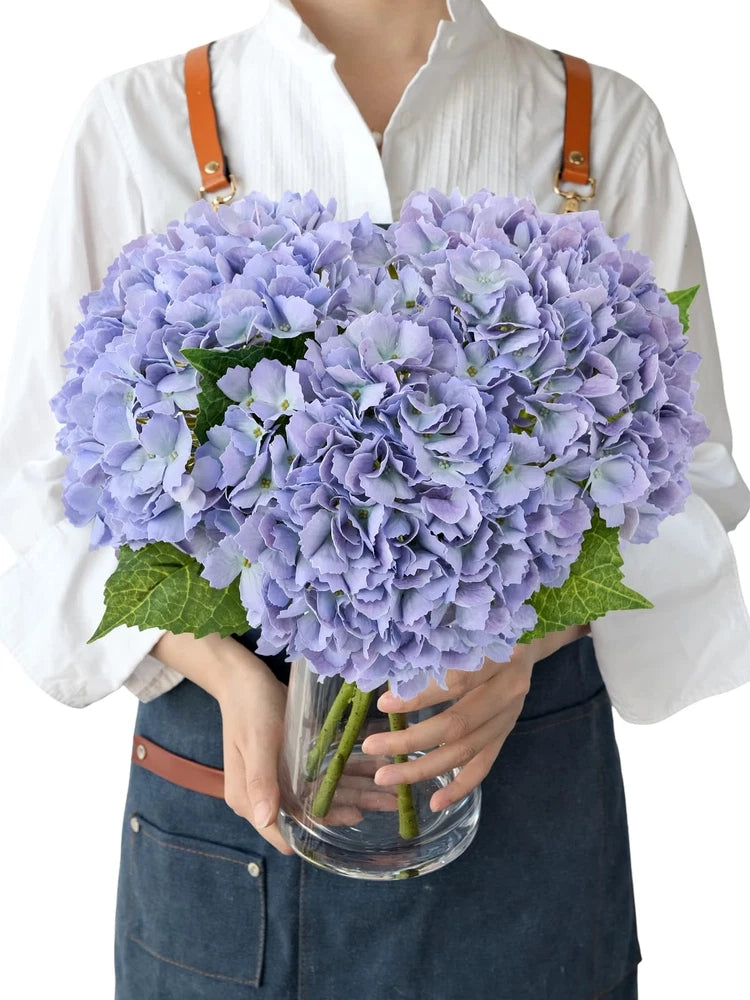 Artificial lavender hydrangea flower bouquet in clear glass vase