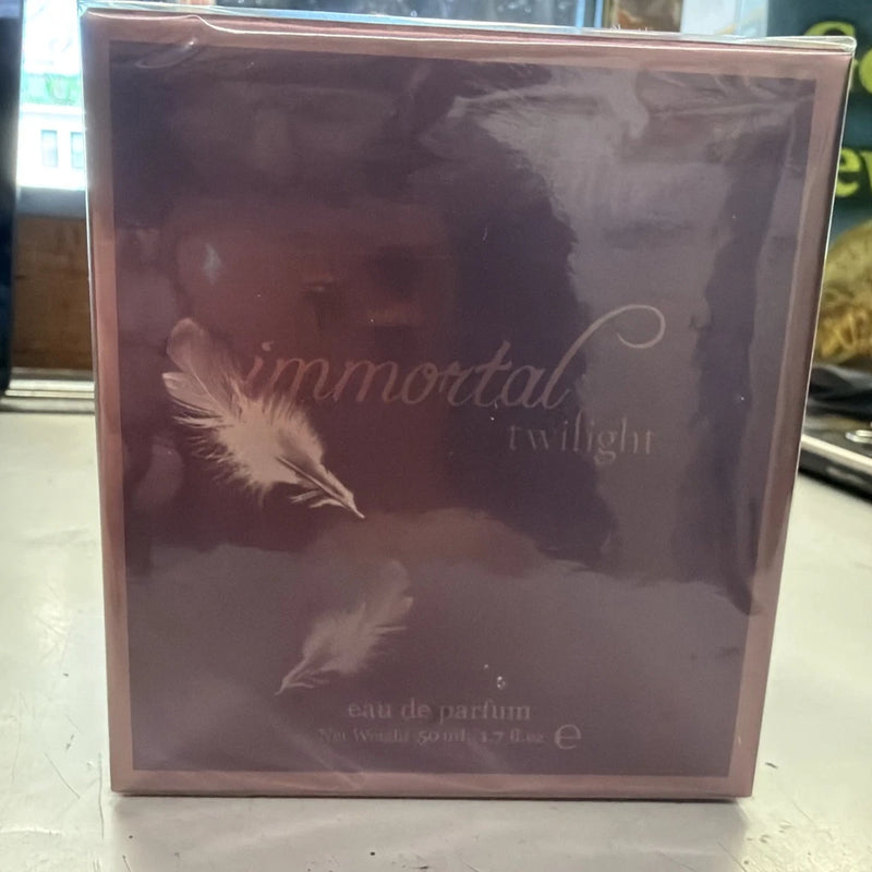 Immortal Twilight perfume gift box with feather illustration and purple design