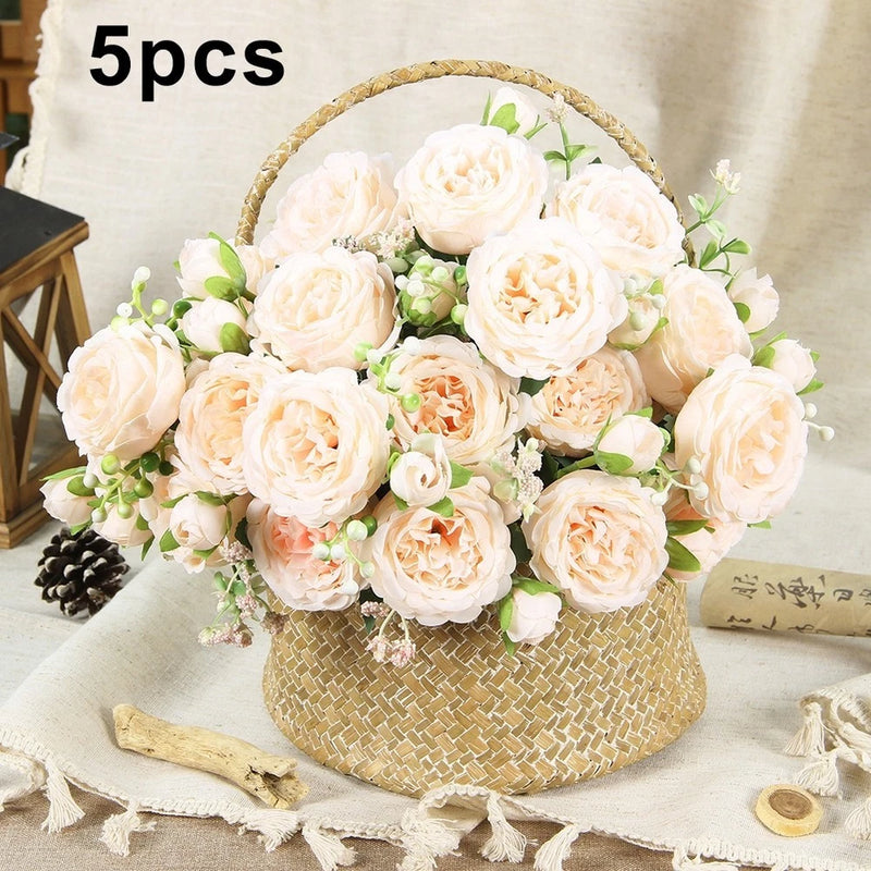 Silk peony flower bunches: cream white blooms with green leaves in woven basket