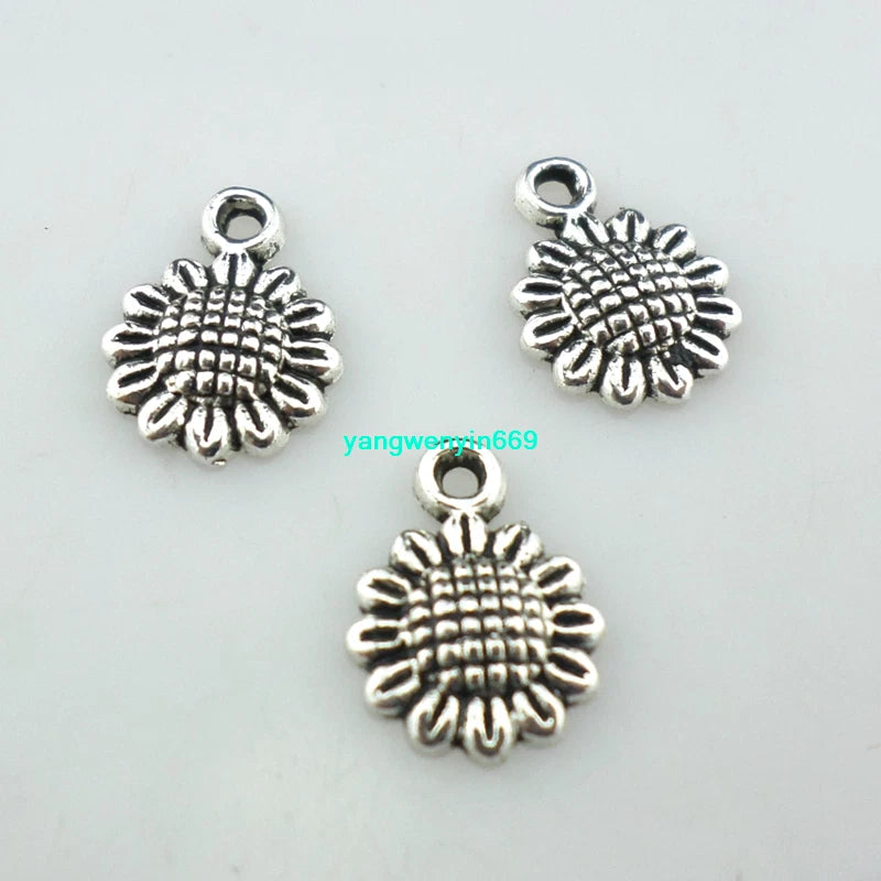 Tibetan silver sunflower charm pendant with small loop, textured petal design