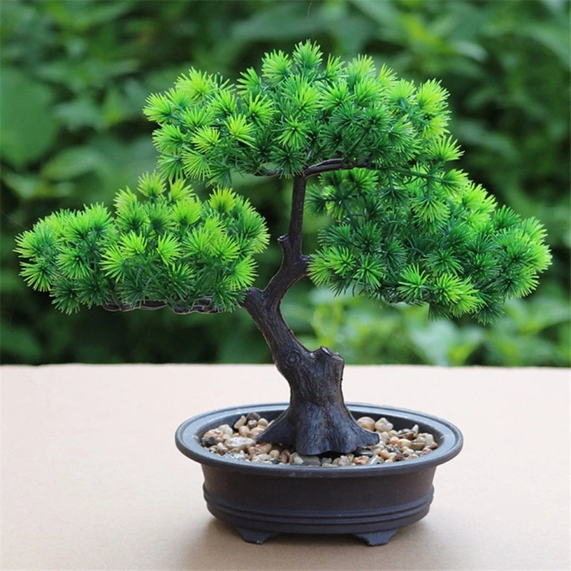 Artificial bonsai tree in round dark pot, green pine-like foliage and textured trunk