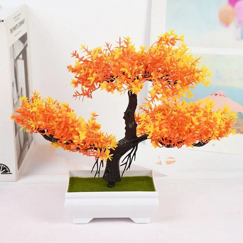 Artificial bonsai tree in white pot with dense orange flower-like foliage