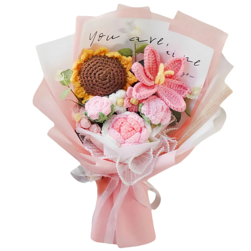 Crochet flower bouquet with pink and yellow yarn flowers, wrapped in pink tissue.