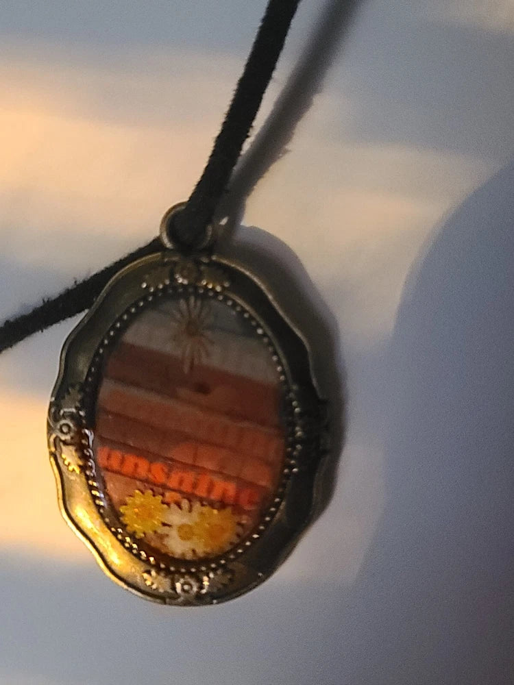 Handmade sunflower pendant necklace with oval dark bezel and sunflower scene inlay