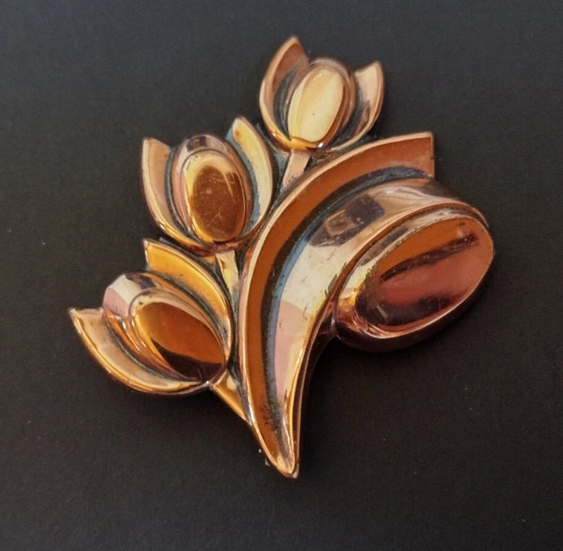 Shiny gold floral oval brooch with layered petal leaves and central oval detail