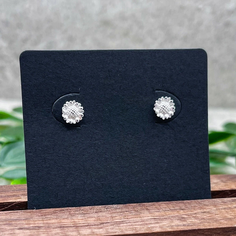 Sterling silver sunflower stud earrings with textured floral center, round stud backs