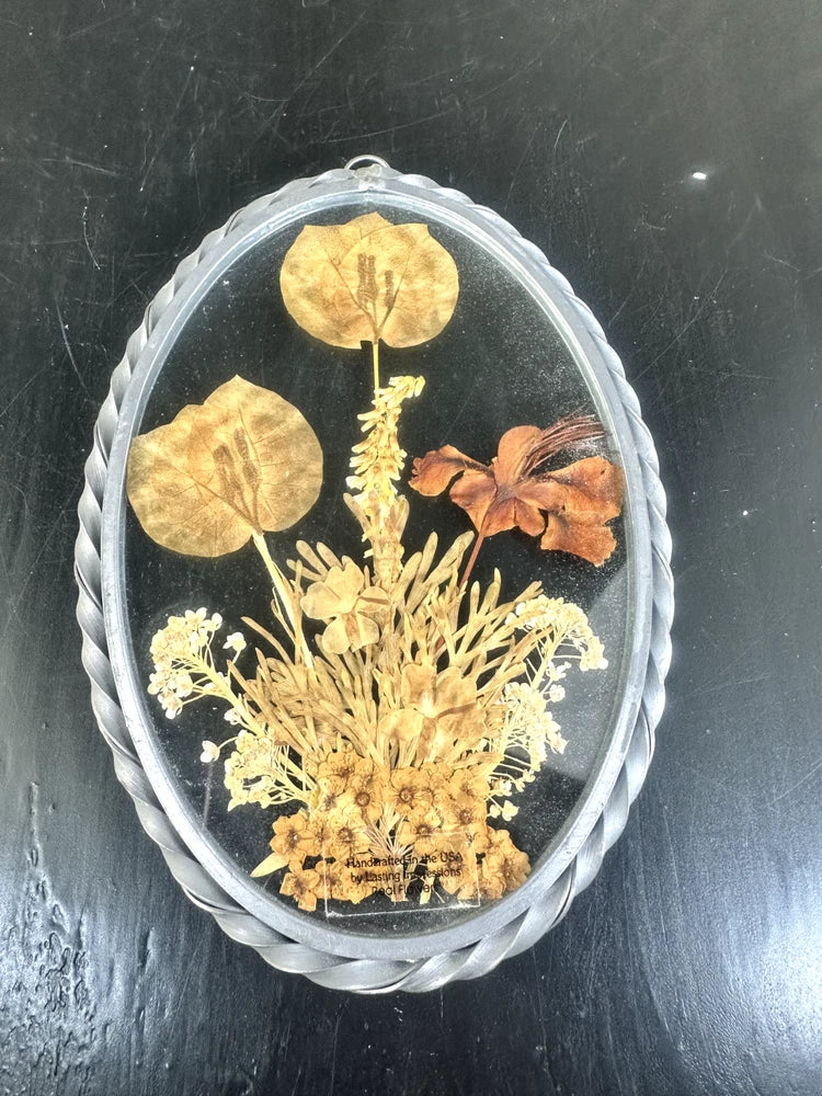 Pressed dried flower oval wall art in glass frame with leaves and blossoms