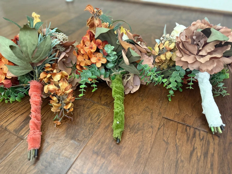 Set of three handmade fall bridesmaid bouquets with mixed flowers and green foliage