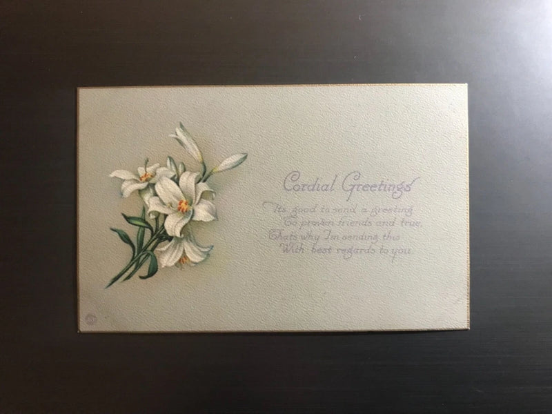 Lilies greeting postcard with white flowers, green leaves, and 'Cordial Greetings' text