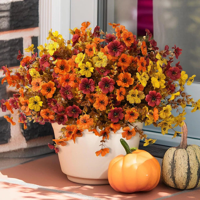 Artificial faux fall flower plant arrangement with orange, yellow, and red blooms in pot