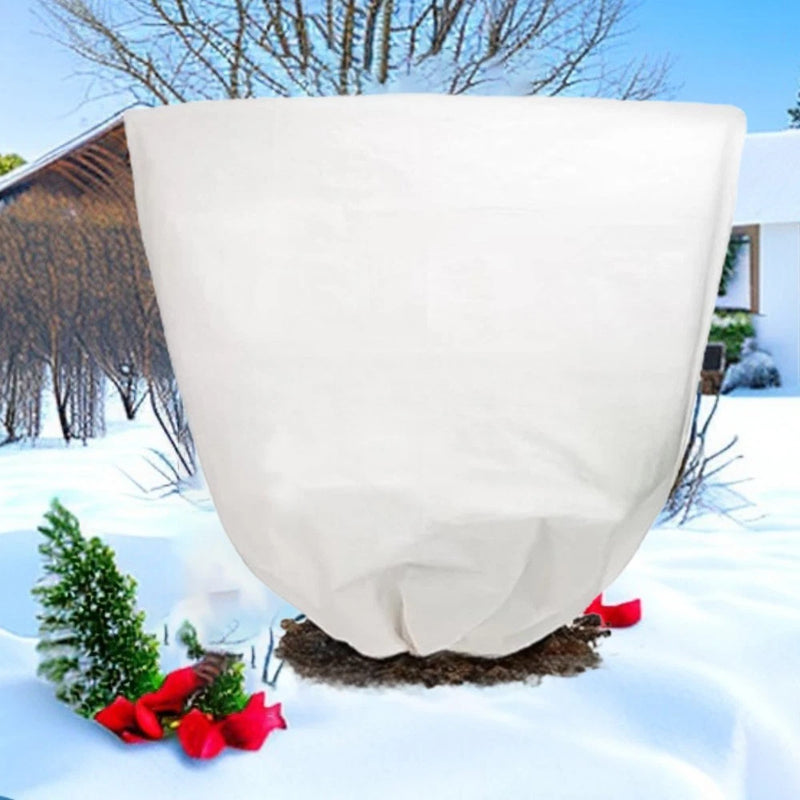 Thick white non-woven plant frost cover fabric, draped over garden plants