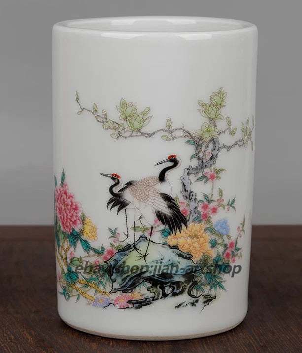 White porcelain brush pot with painted crane, tree, and peony flowers around the sides