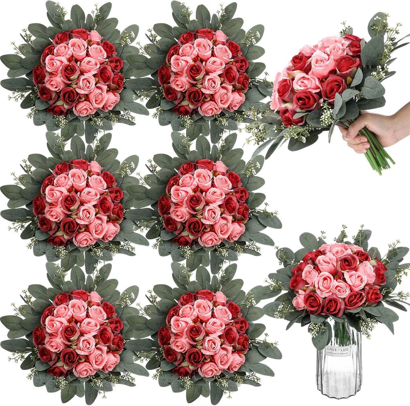 Silk rose bouquet set with pink blooms and green leaves; one bouquet held in hand