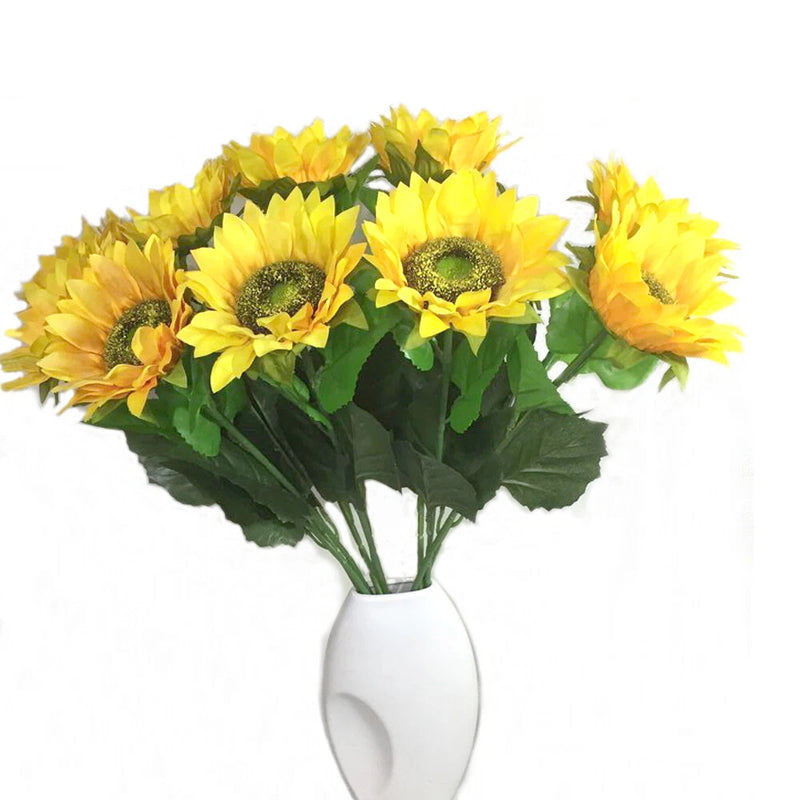 Artificial sunflower bouquet with bright yellow blooms and green leaves in a white vase