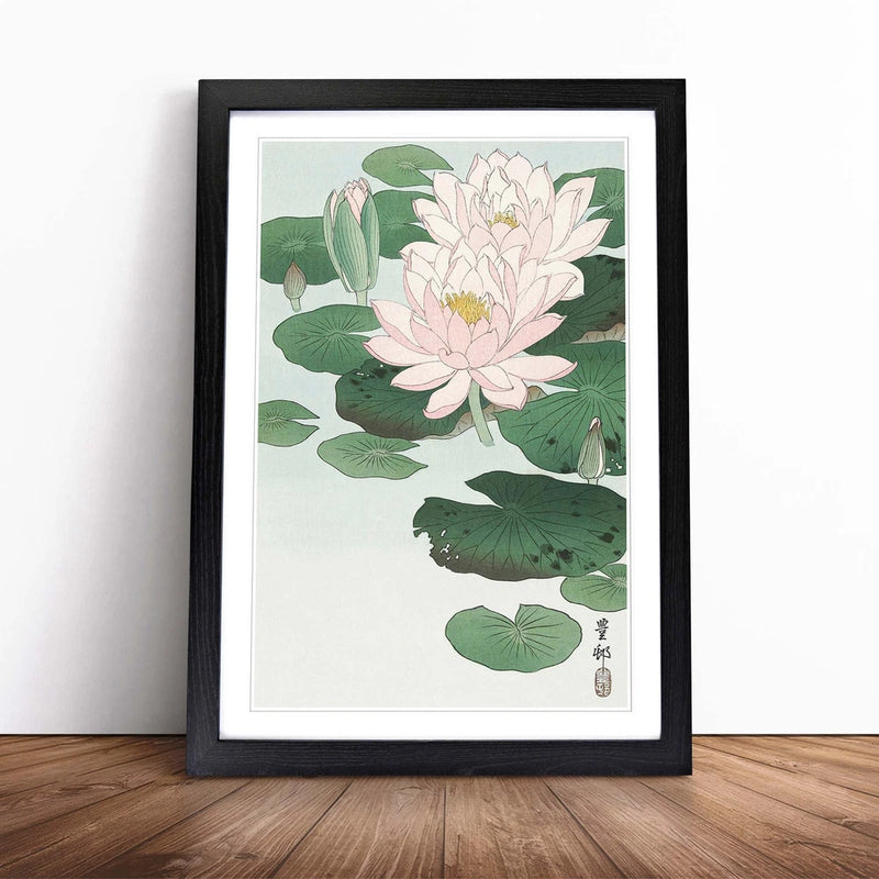 Framed canvas wall art with pink water lily blossoms and green leaves, black frame