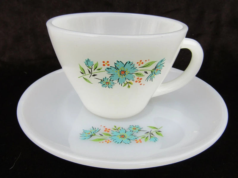 Vintage white cup and saucer with blue, green, and orange floral band
