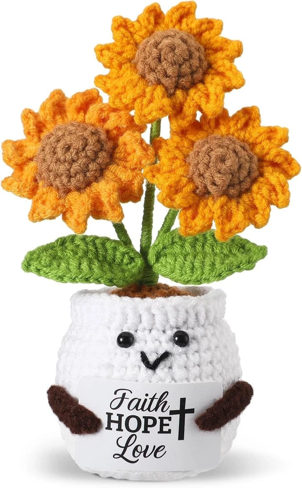 Crocheted sunflower gift with orange blooms and white pot text: Faith HOPE Love