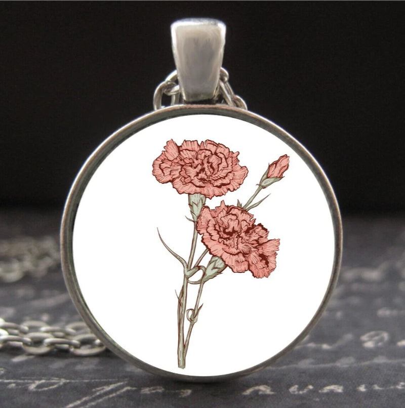 Round silver-tone necklace pendant with pink carnation flower design