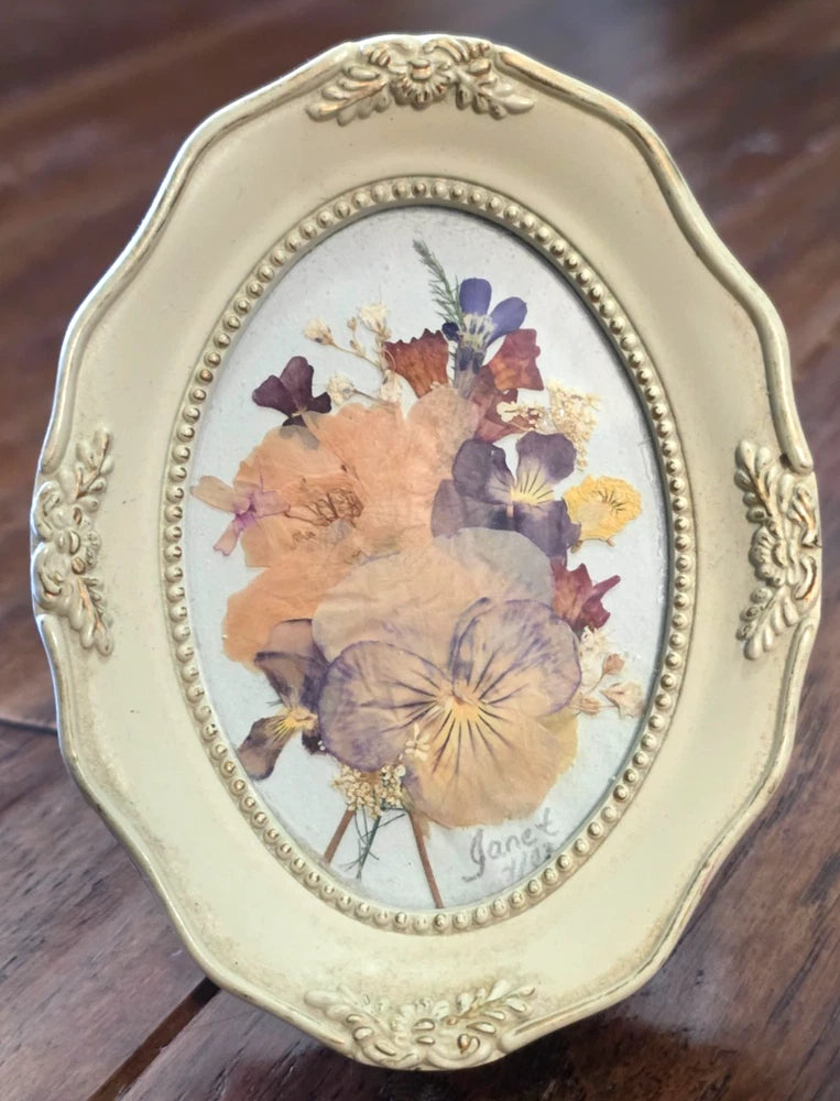 Ornate oval tabletop frame with pressed dried flowers in purple and beige
