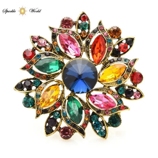 Gold-tone sunflower crystal brooch with multicolor stones and central blue gem