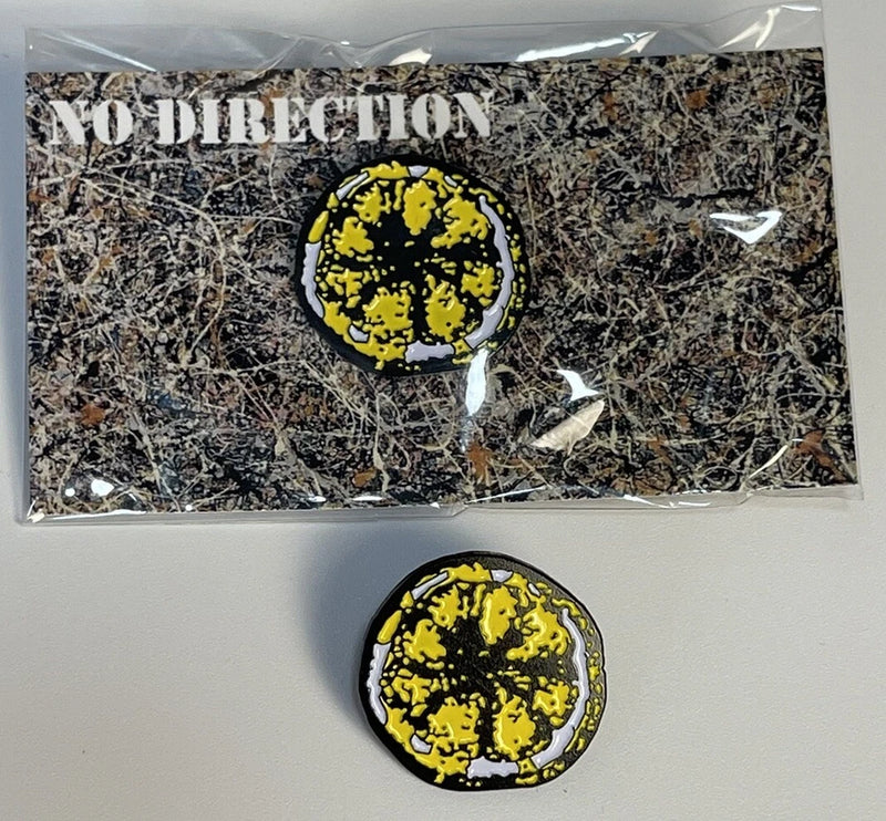 Round enamel pin with yellow-and-black graphic and silver edge border