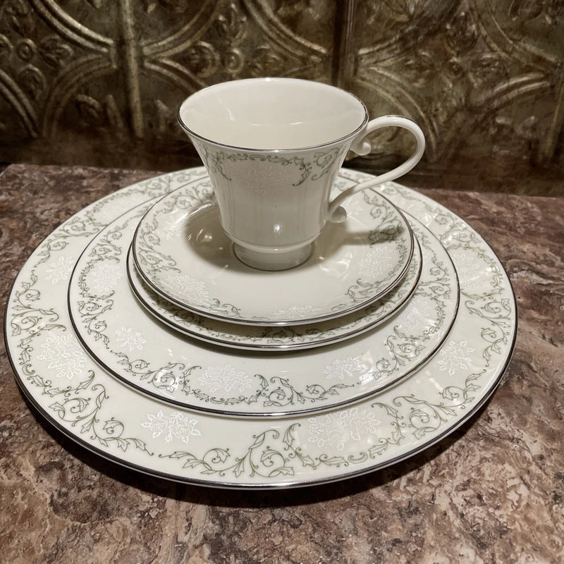 Porcelain tea cup with handle, matching saucer and plate, white with green floral trim
