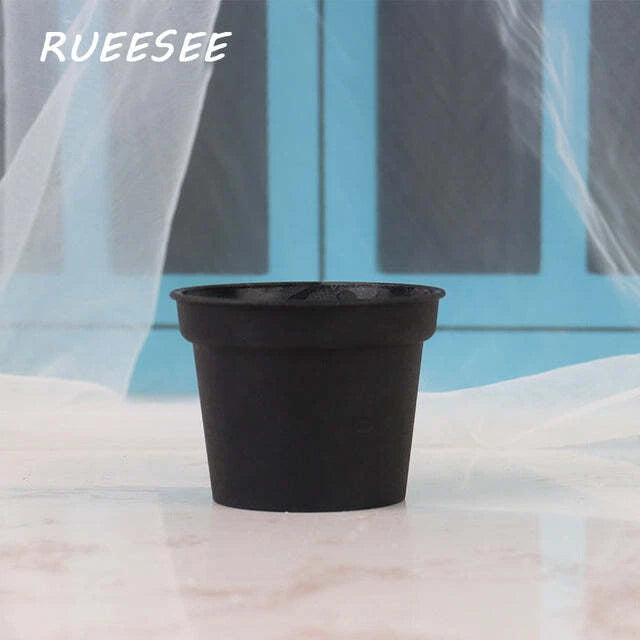 Artificial bonsai plant in a small black potted planter