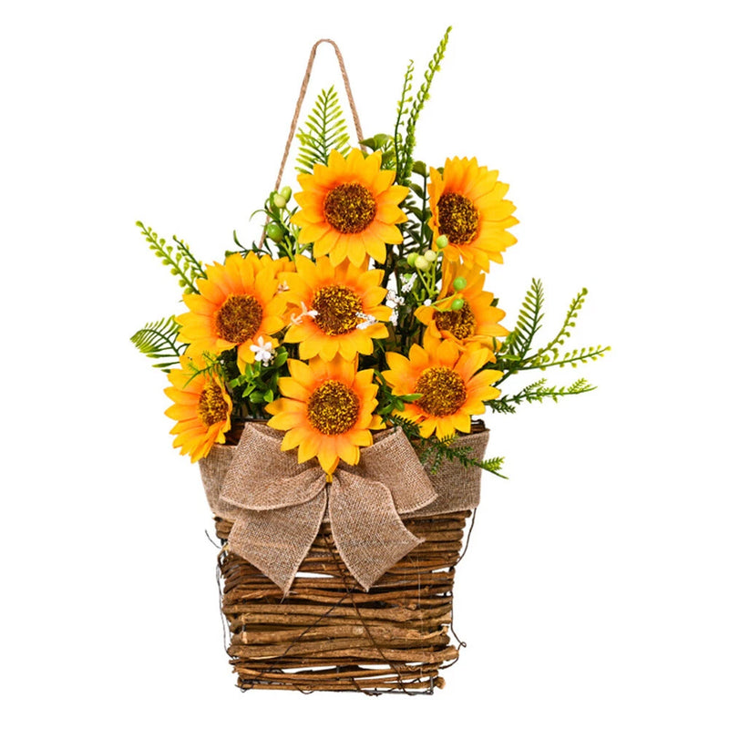 Artificial sunflower arrangement in a woven basket with burlap bows and green leaves