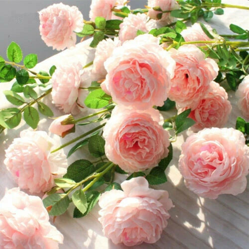 Pink artificial peony silk flower bouquet with layered blooms and green leaves