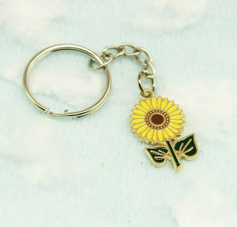 Sunflower enamel keychain with gold-tone ring, chain, and flower with green leaf charm