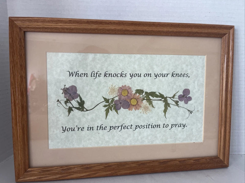 Wooden-framed wall art with pressed dried flowers and a prayer quote