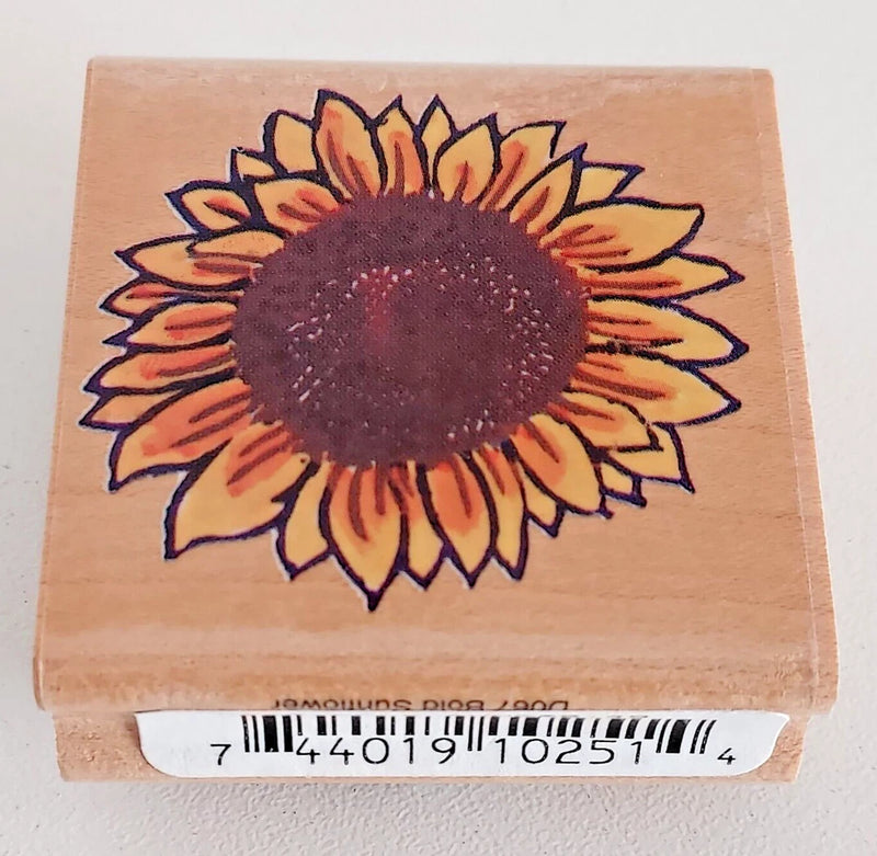 Sunflower rubber stamp on wooden block, bold dark center with orange and blue petals