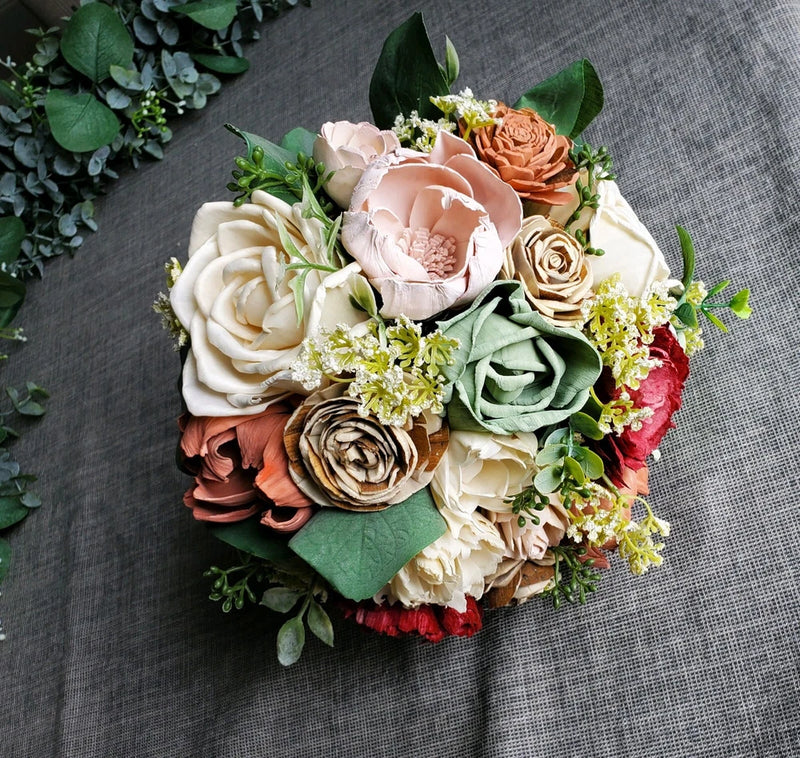 Bridal bouquet with pink and cream faux roses, sage greenery, and eucalyptus sprigs