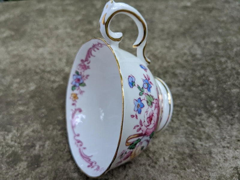 Porcelain floral teacup with handle, white with pink blue green yellow flower design