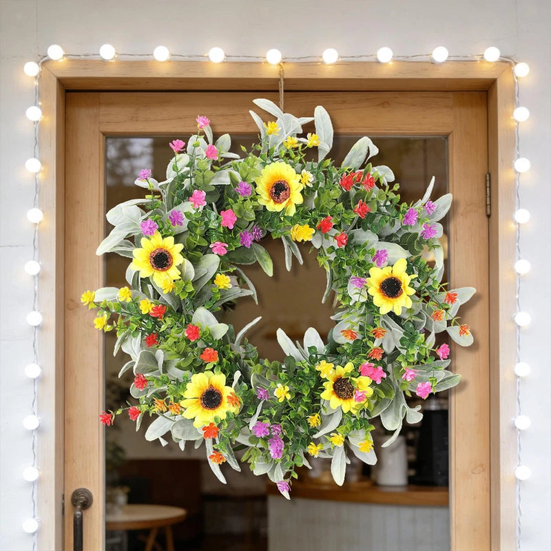 Artificial sunflower and mixed wildflower wreath with pink, yellow, red blooms and green leaves