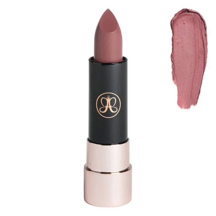 Matte lipstick bullet in rose pink with black cap and gold logo on the tube