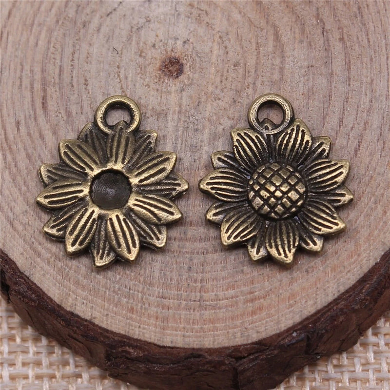 Antique bronze sunflower charm pendant with loop bail, textured petals and center