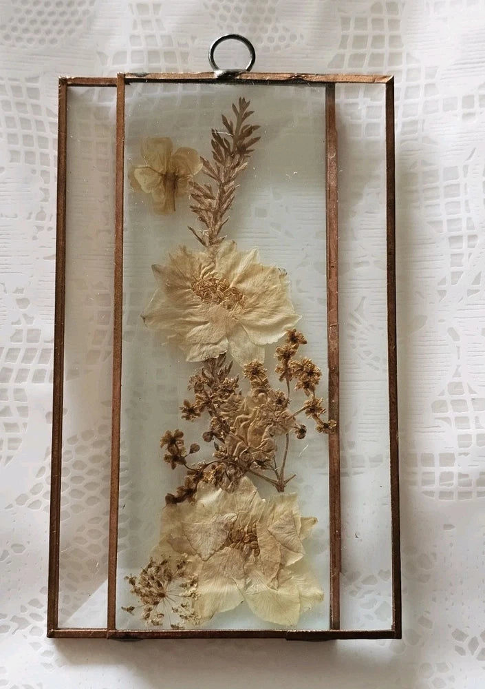 Rectangular beveled glass terrarium with faux dried flowers in brown frame