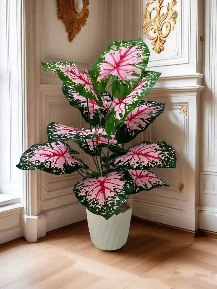 Large simulated palm tree decor with pink-and-green leaves in a white pot