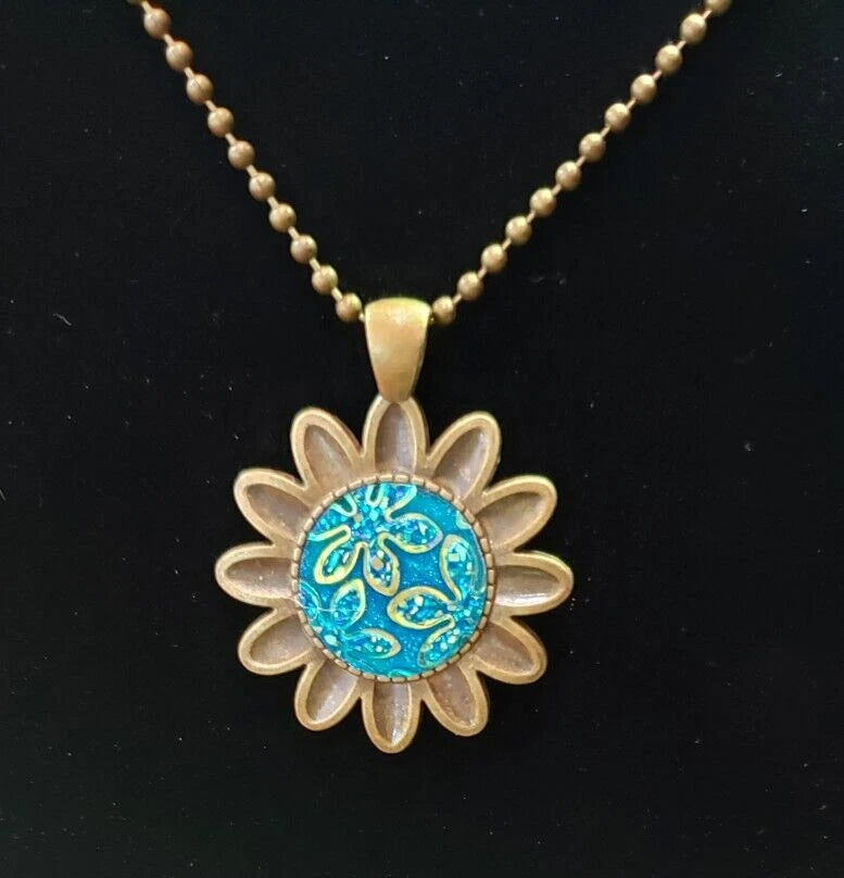 Bronze sunflower pendant necklace with sparkly blue cabochon on bead chain